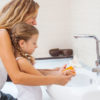 Mom and daughter at sink handwashing